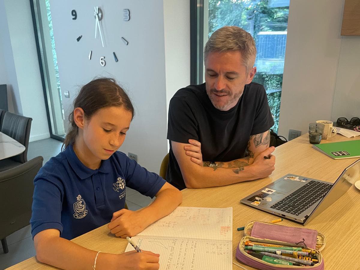 Thomas Williams mentoring a student in a library setting